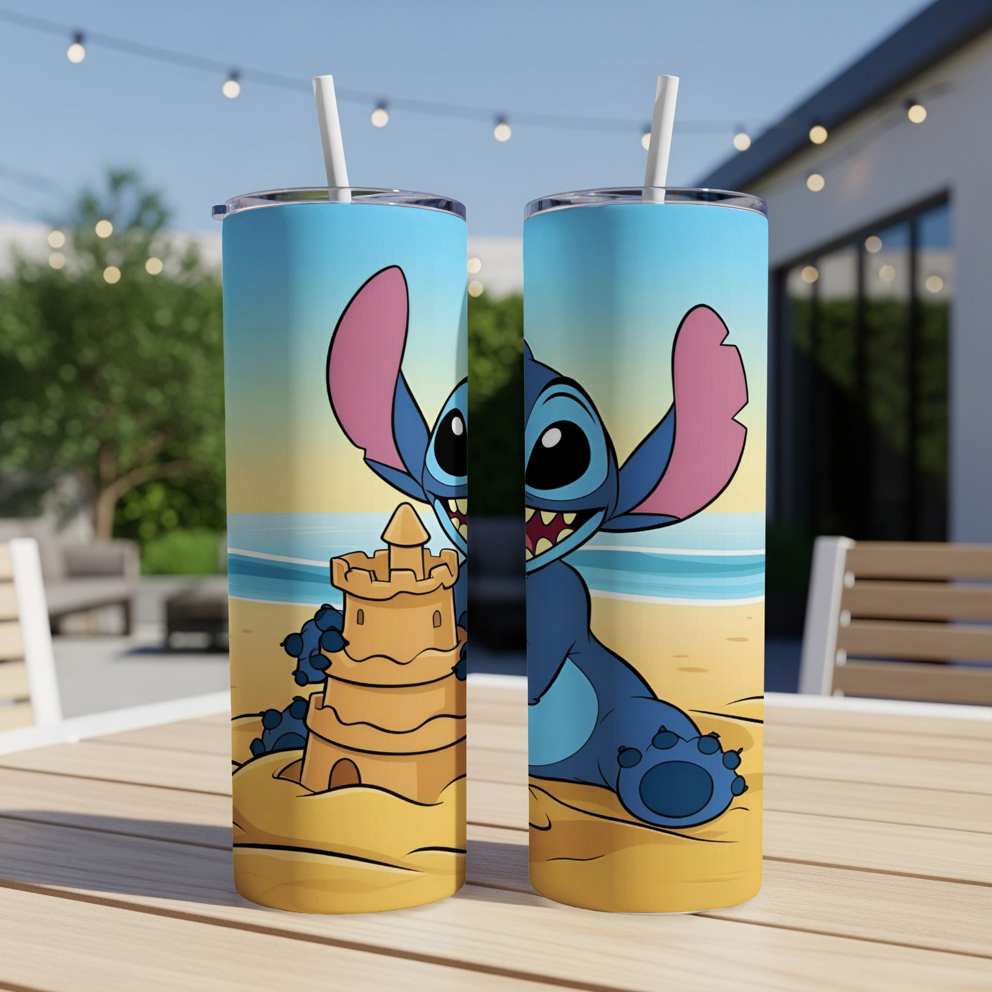 Blue Stitch character in sandcastle on a beach printed on a two-sided tumbler.