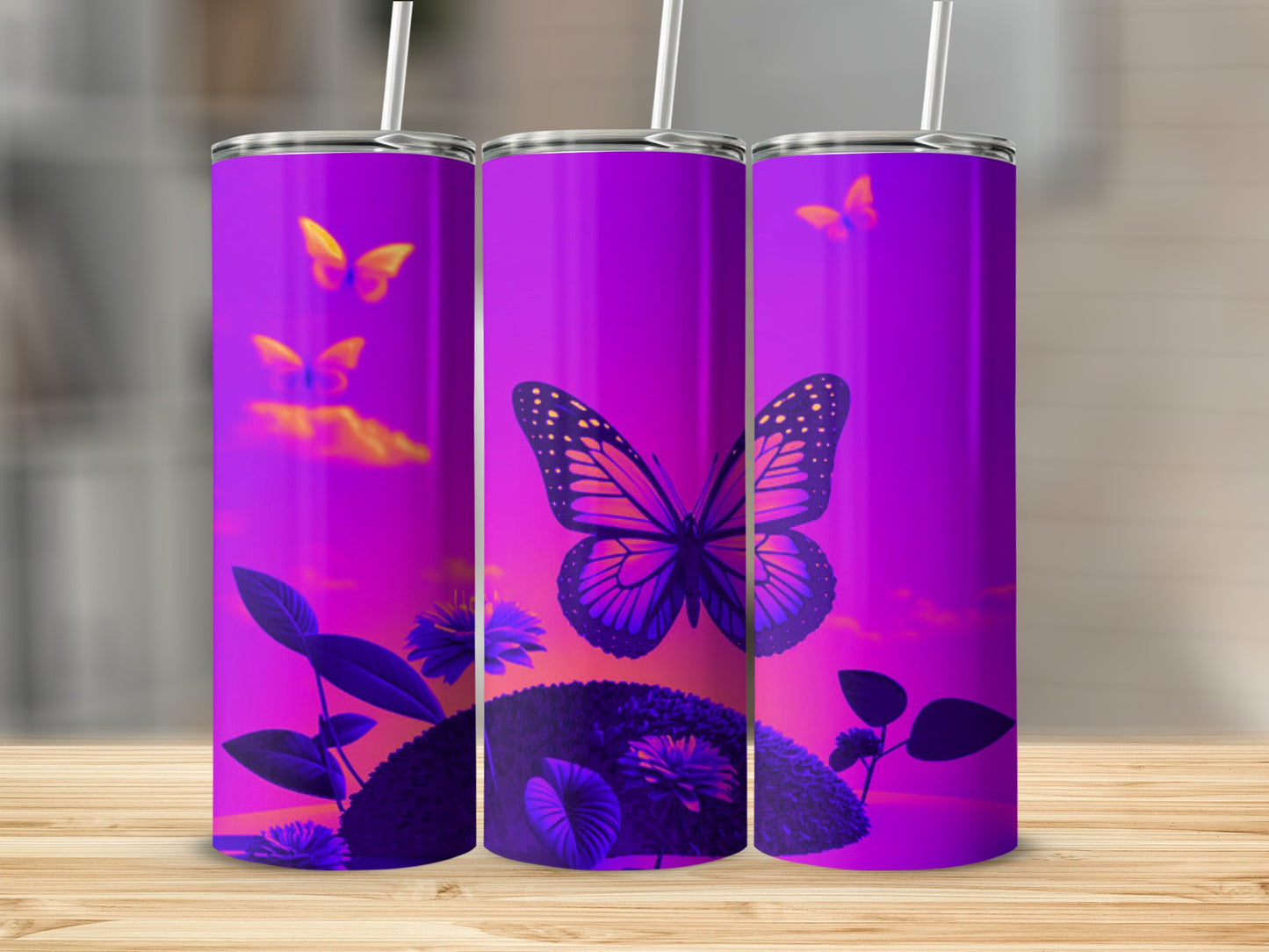 Three purple tumblers with a butterfly and floral design against a sunset background.