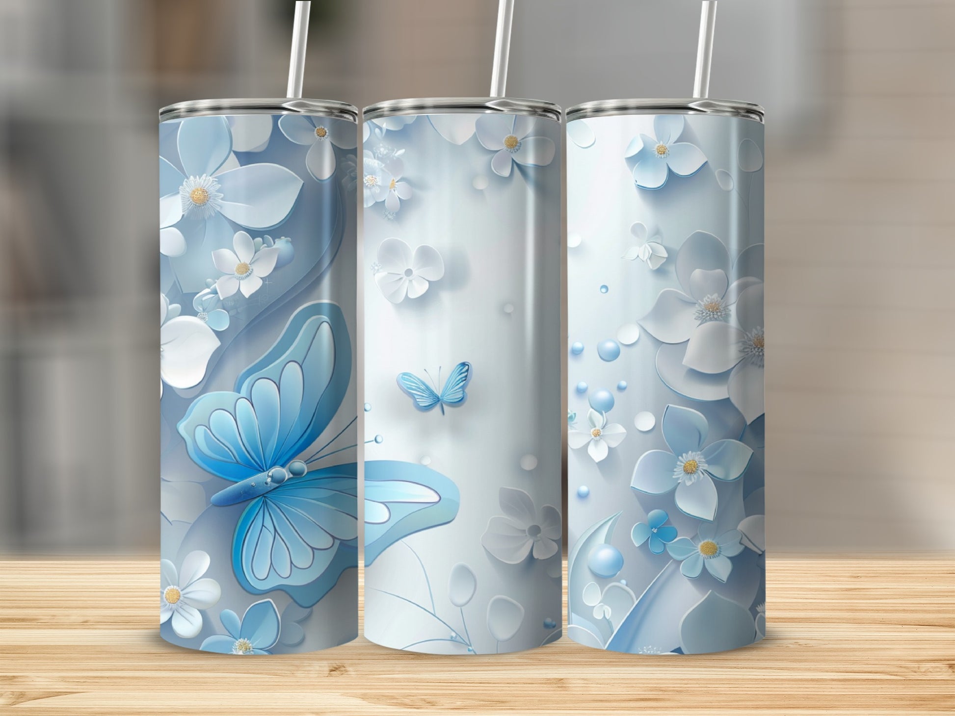 Three blue floral tumblers with a butterfly design.