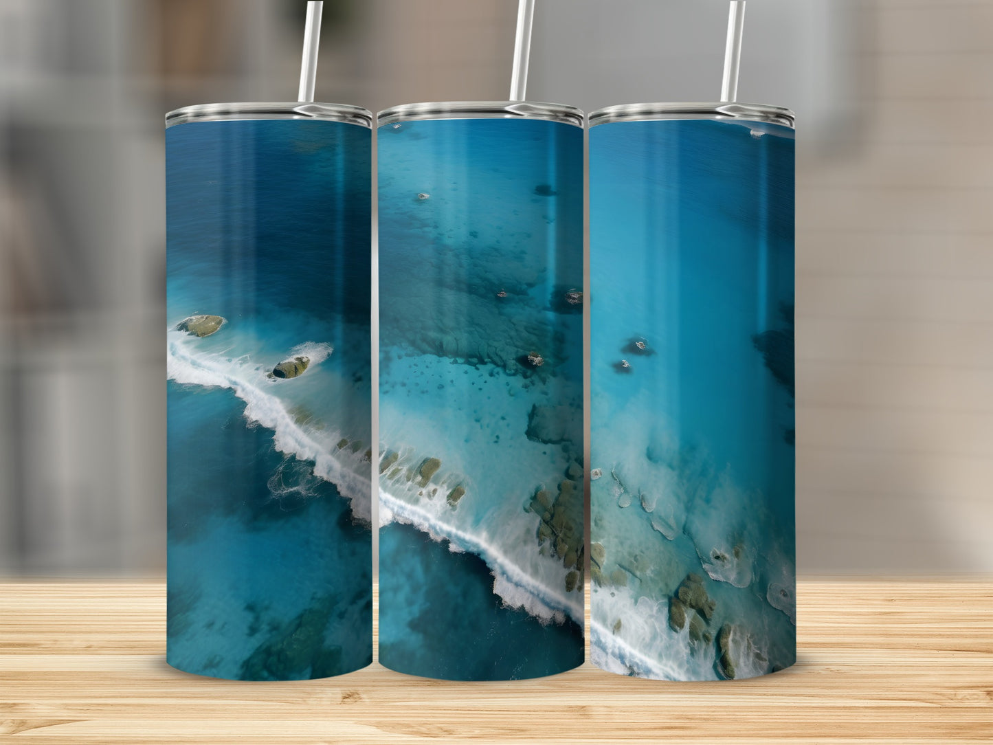 Three tumblers displaying aerial ocean views with white waves and rocky islands.