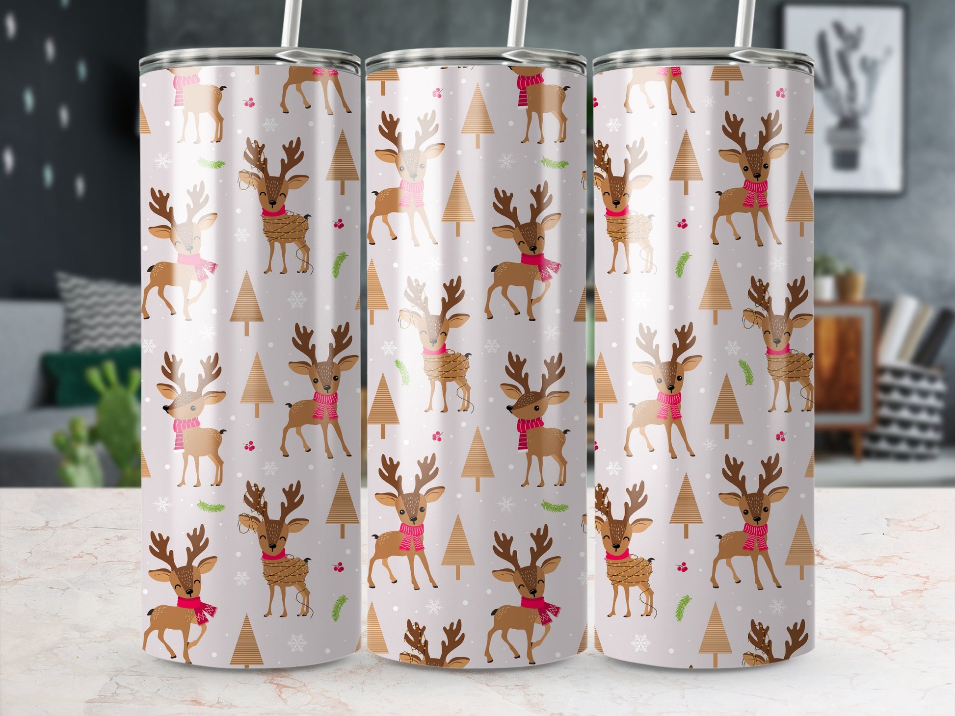 Pattern of deer and trees on a light pink Christmas tumbler.