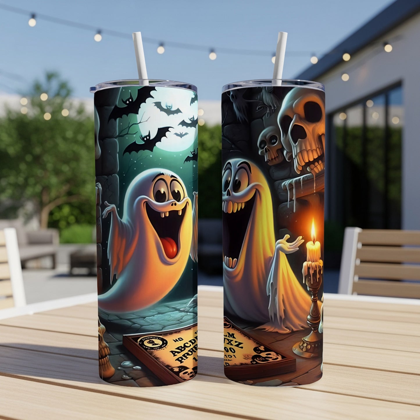 Two tumblers with cartoon ghosts, bats, skulls, a ouija board, and a candle.