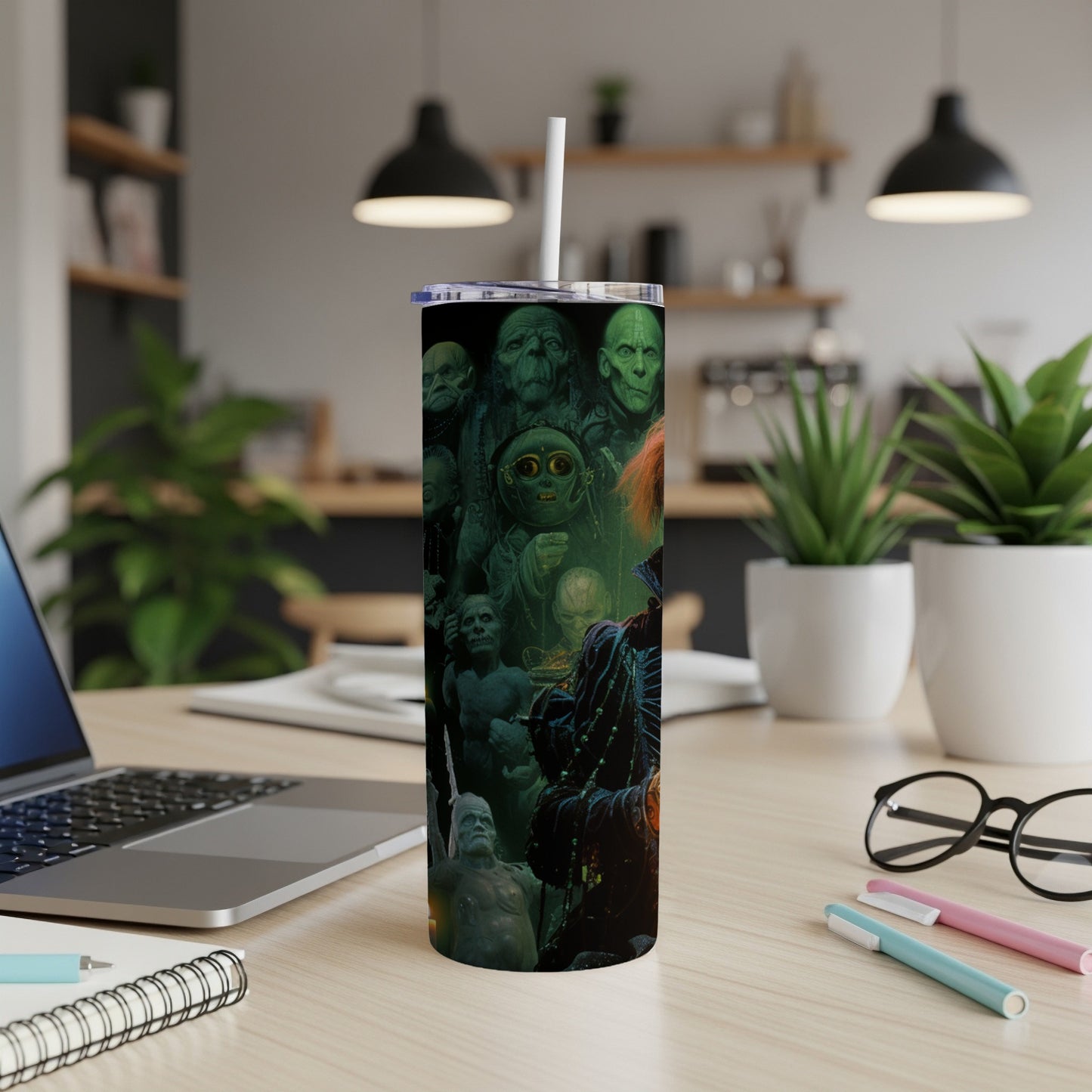 Tumbler with a collage of dark, creepy, green-hued characters and creatures.