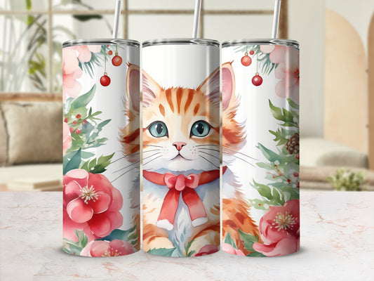 Orange tabby cat with blue eyes and red ribbon on floral tumbler.