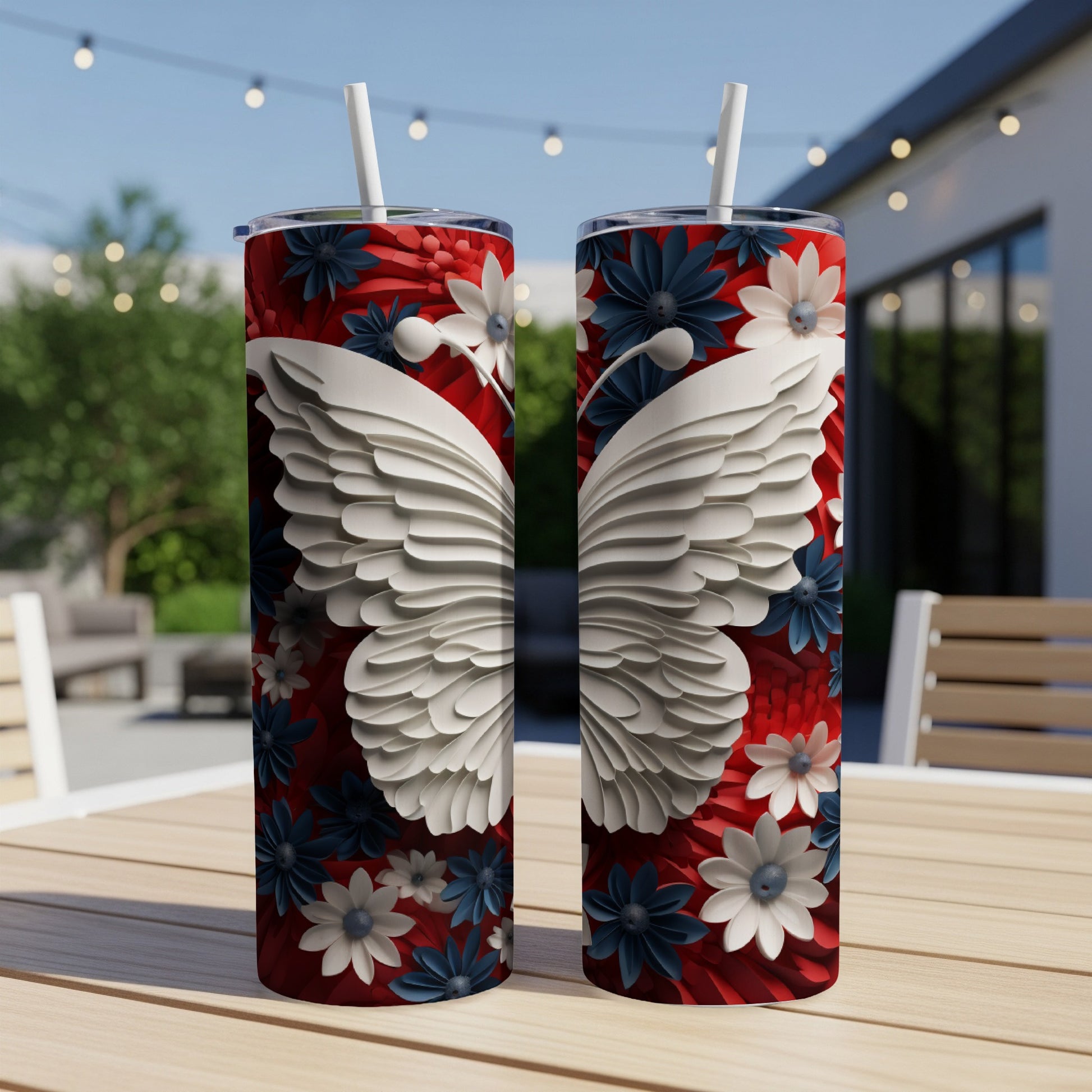 Two patterned tumblers with butterfly wings and floral designs sit on a table.