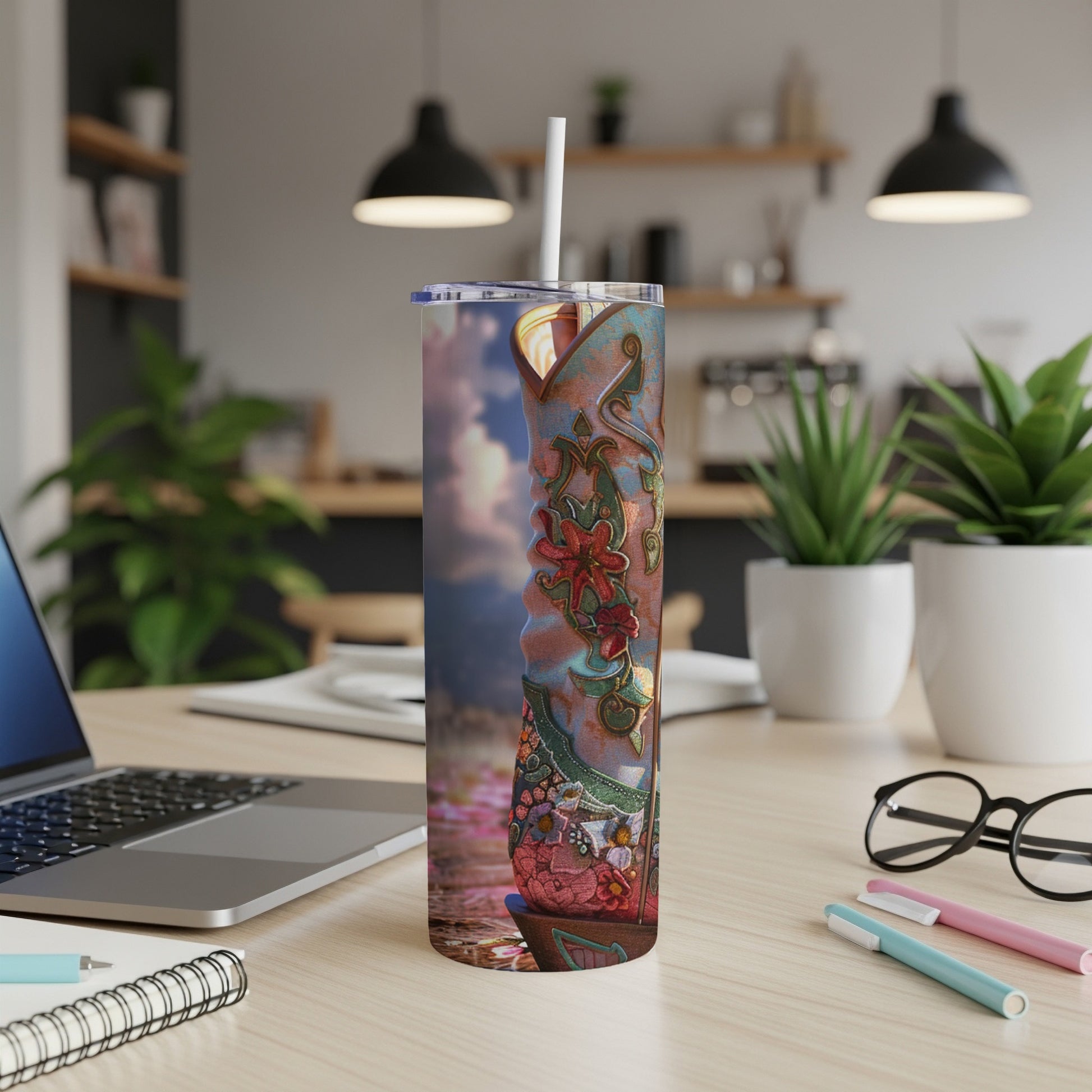 Detailed cowboy boot tumbler with floral and celestial design.