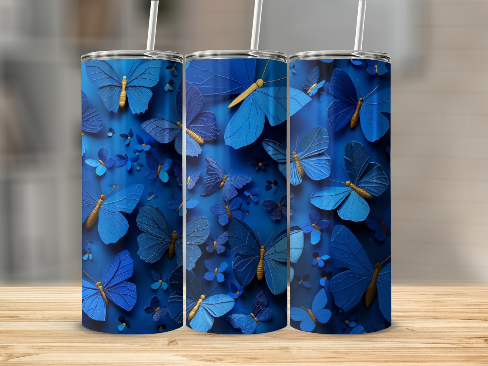 Three blue tumblers with butterfly patterns.