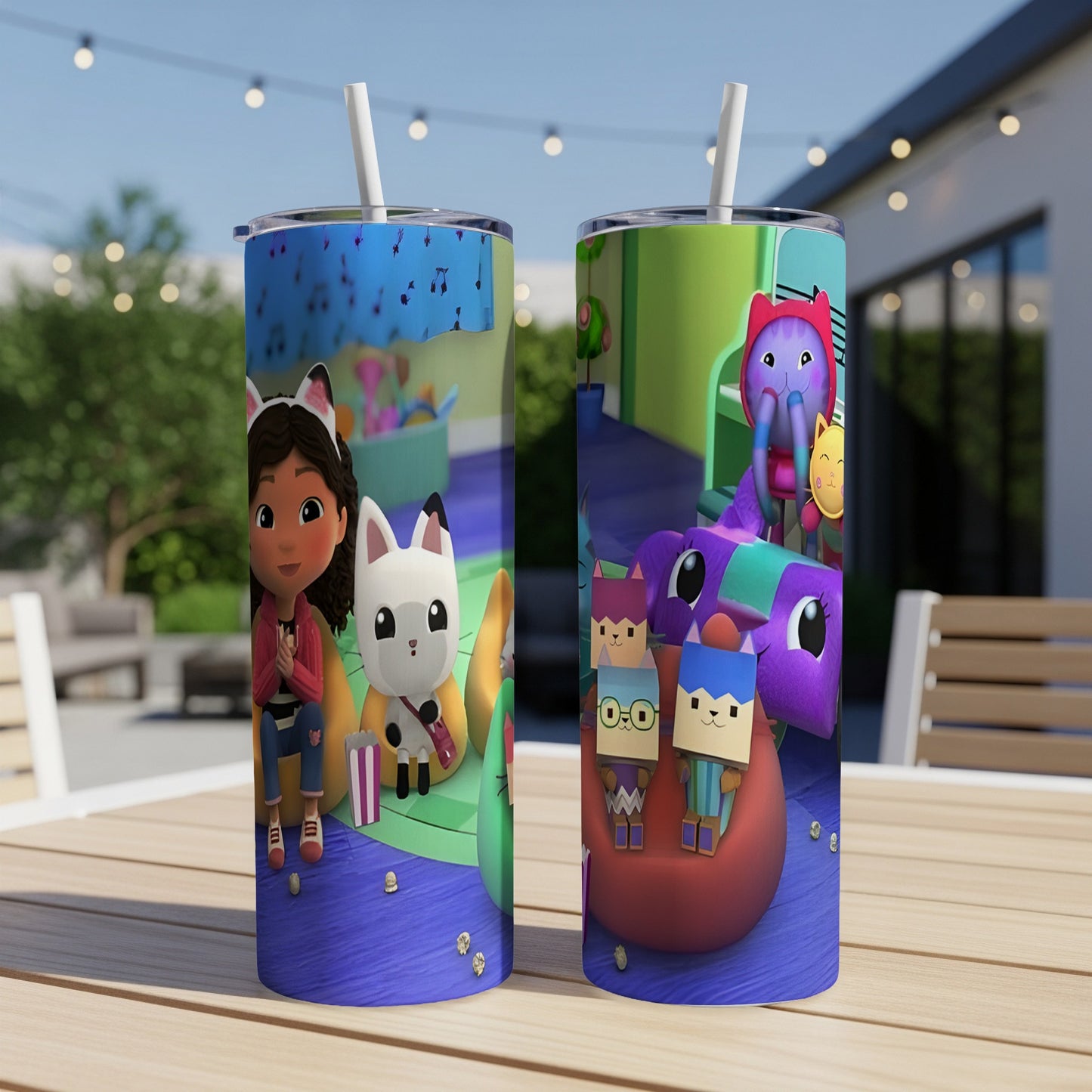 Two Gabby's Dollhouse tumblers with characters on a table.
