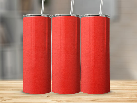 Three red tumblers with white straws on a wooden surface.