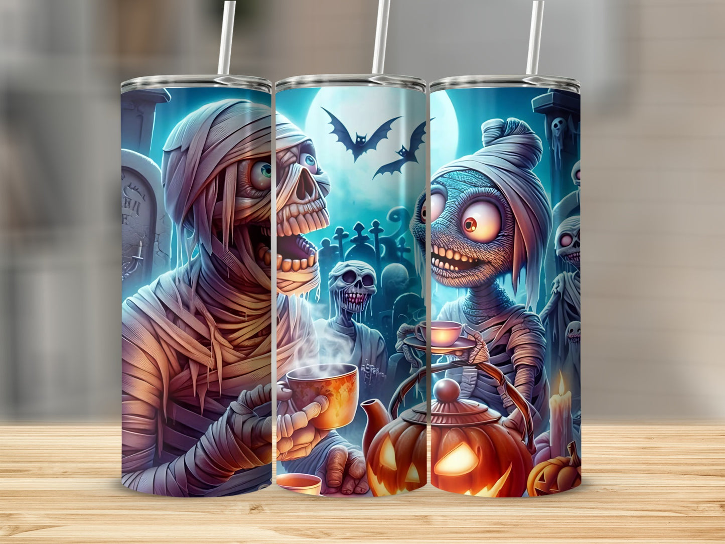 Halloween tumblers with mummy, zombie, and ghost characters in a graveyard scene.