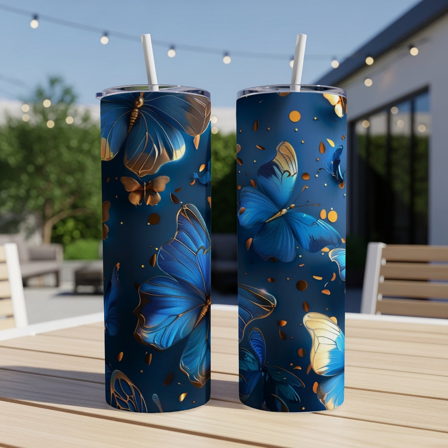 Two dark blue tumblers with gold and blue butterflies and polka dots.