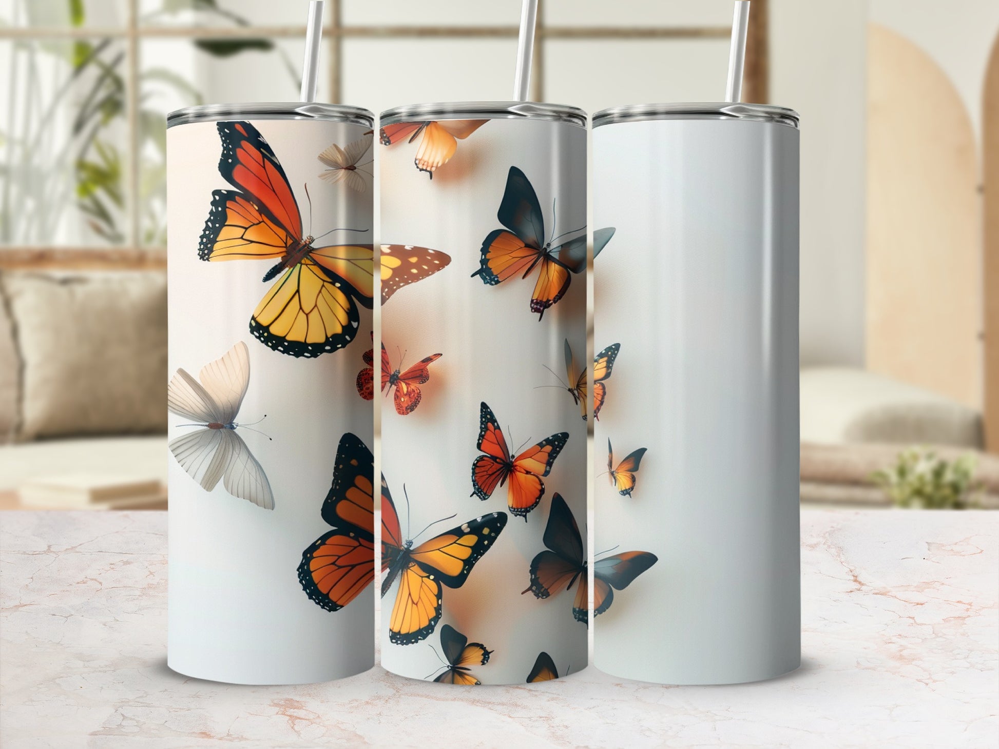 Three tumblers with orange and yellow butterflies on a white background.