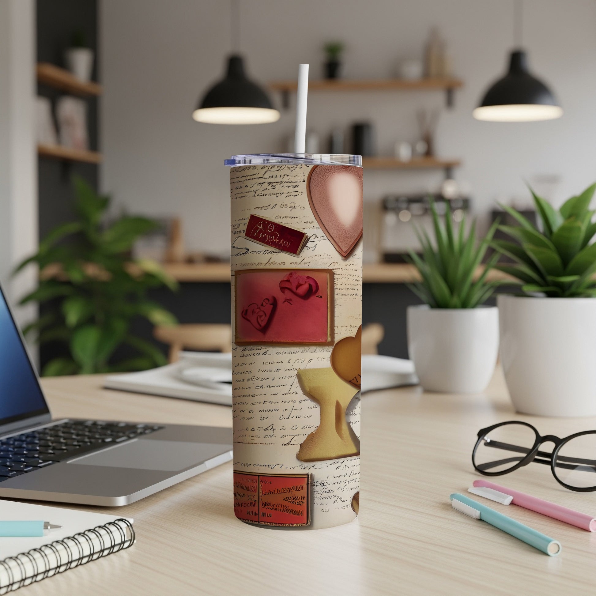 Tumbler with heart designs and handwritten script on a desk.
