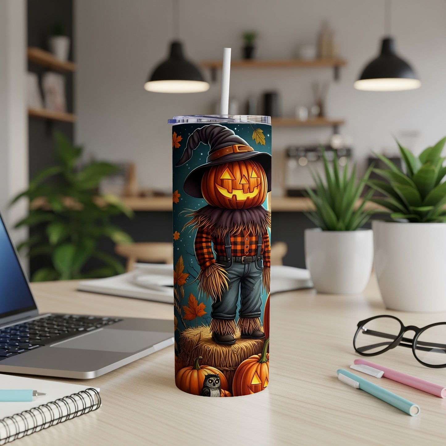 Tumbler with a scarecrow pumpkin design and fall leaves.