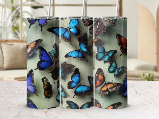 Tumbler with blue and orange butterflies, some with intricate patterns.