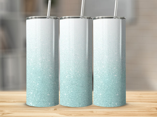 Three tall, frosted tumblers with a white to light blue glitter ombre design.