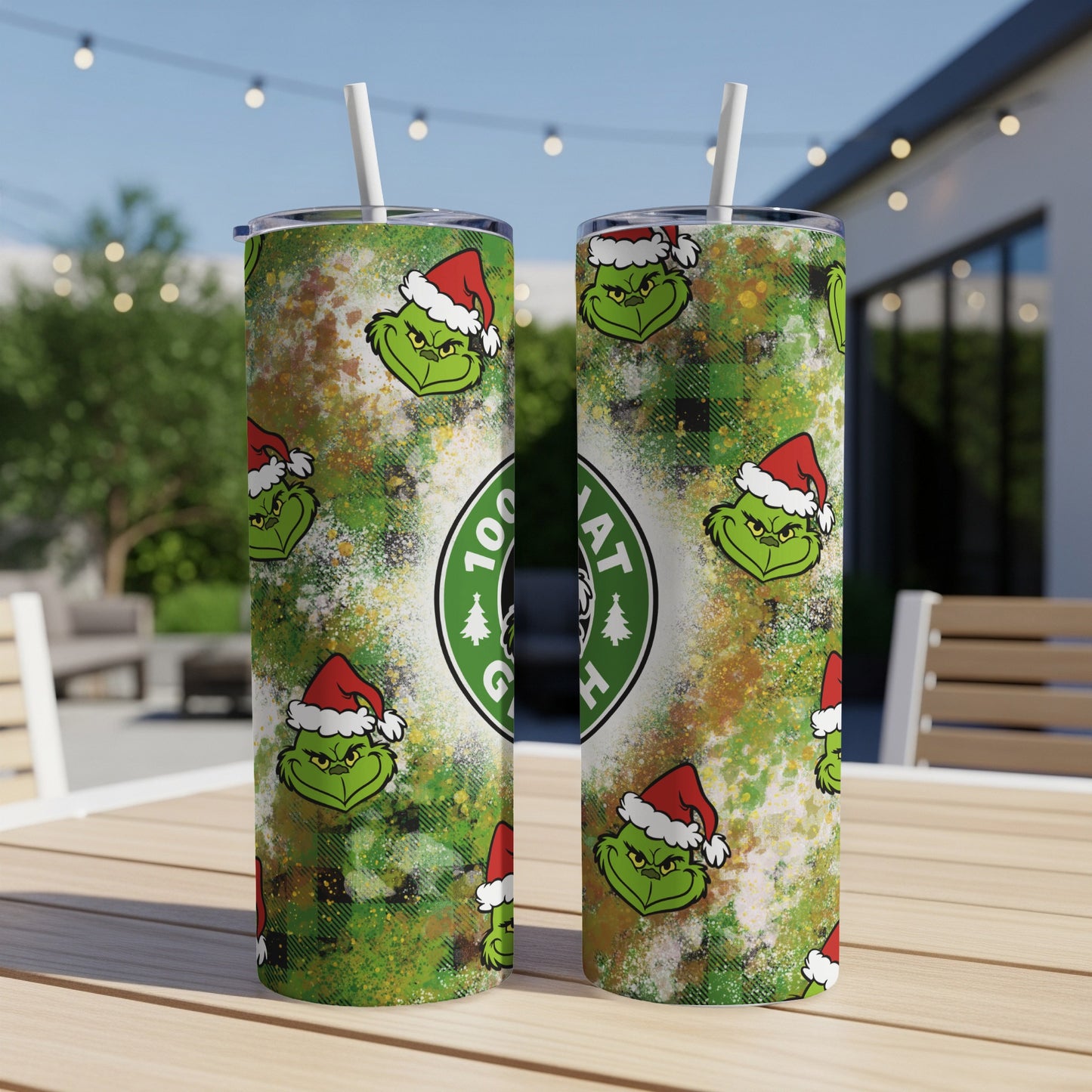 Two tall tumblers with Grinch face pattern and green splatters.