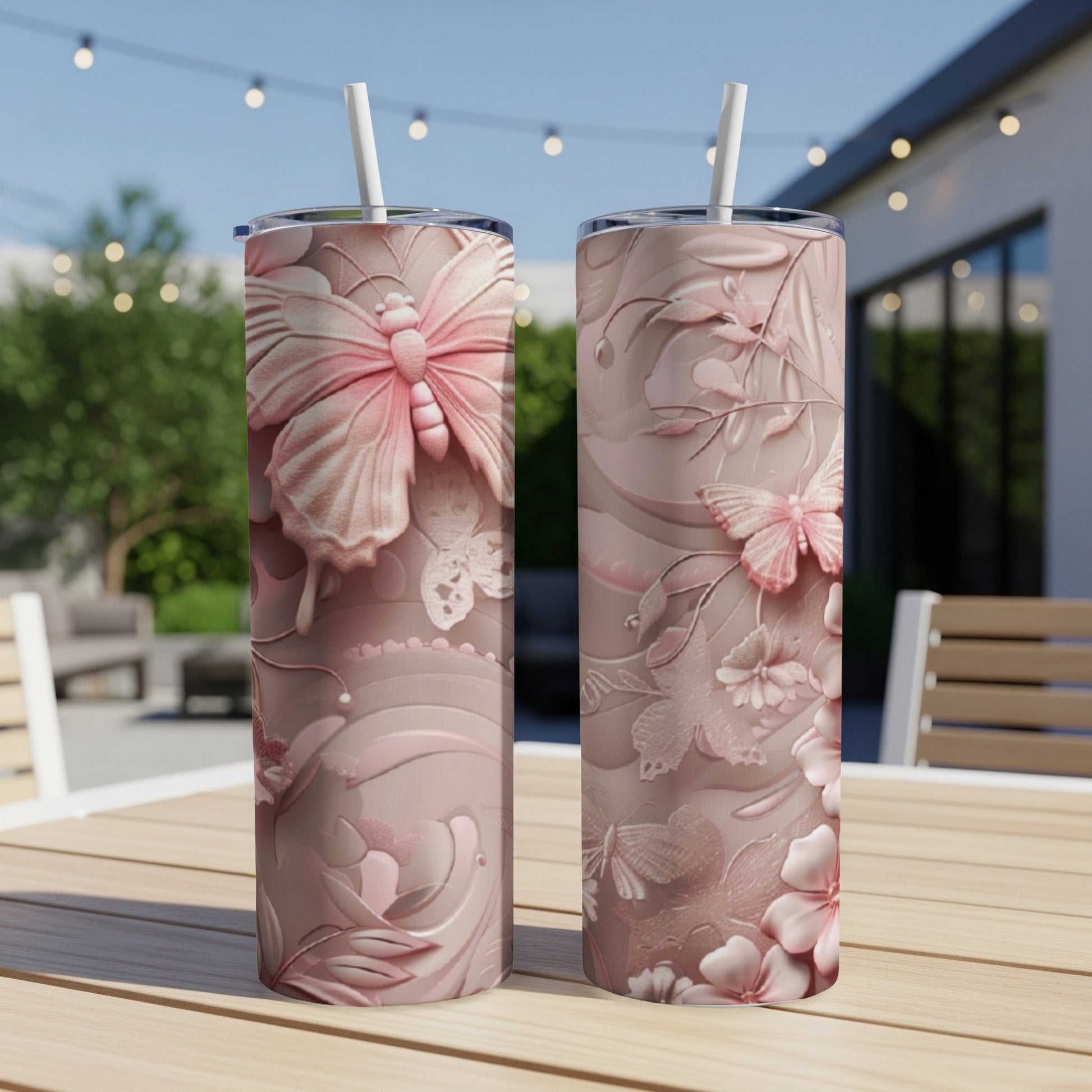 Two pink tumblers with butterfly and floral embossed designs.