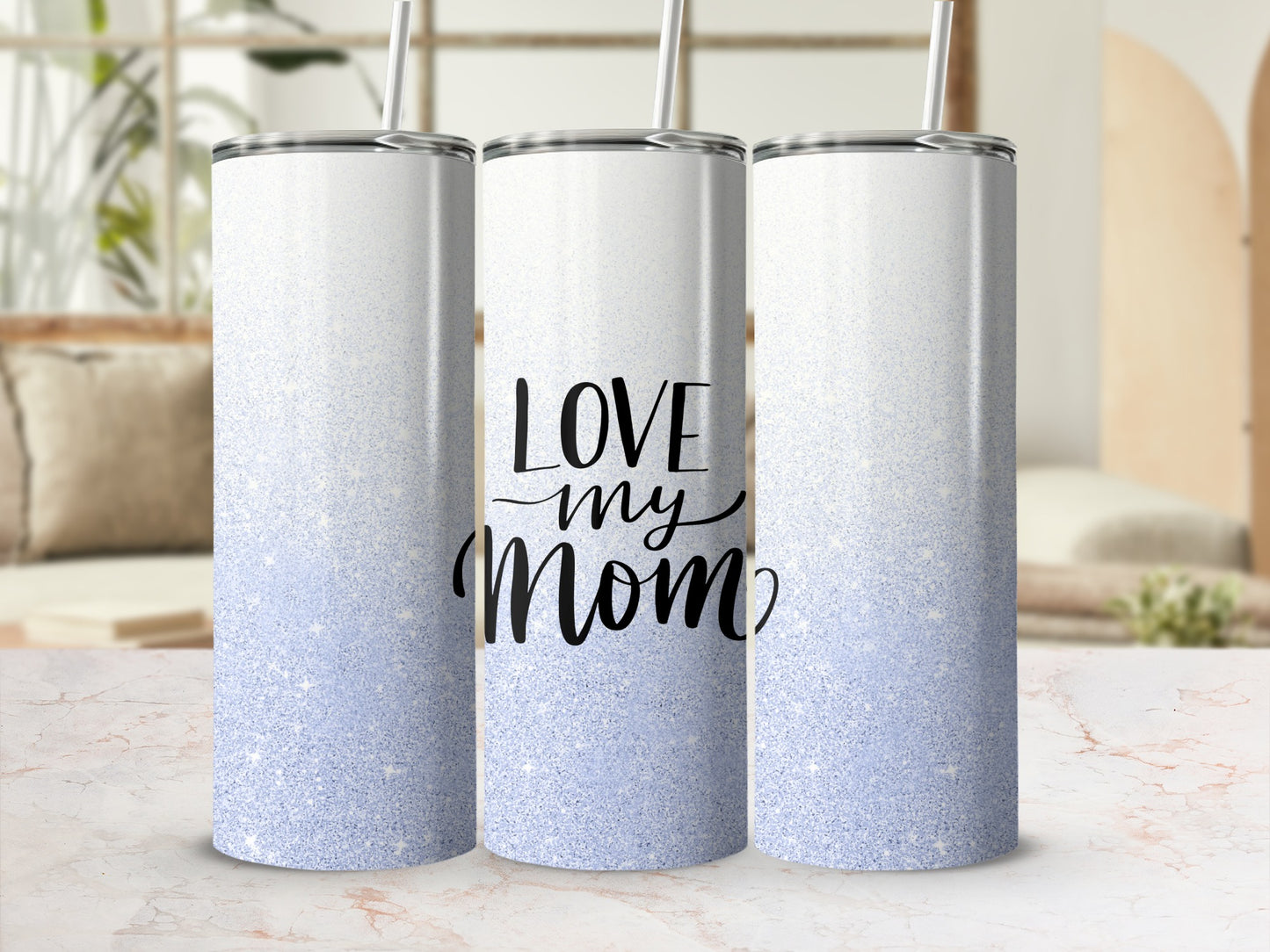 White and blue glitter tumbler with "Love Mom" text in black script.