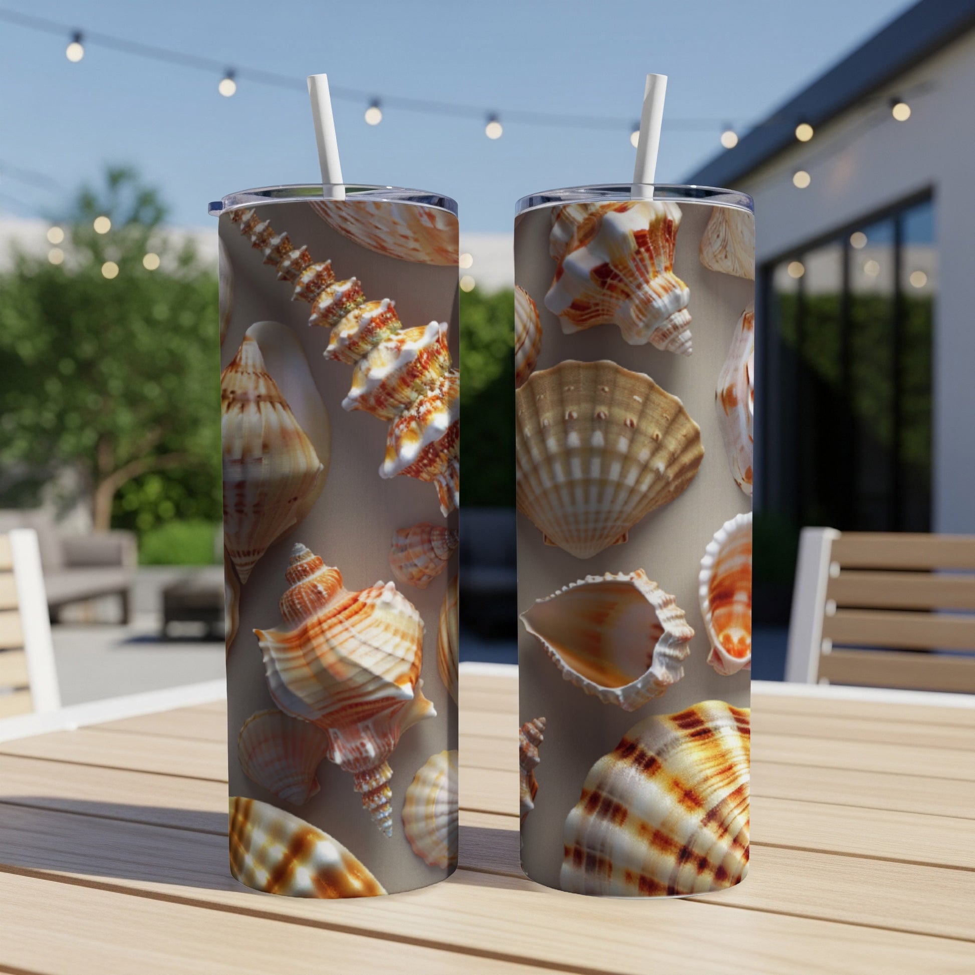 Two tumblers with a seashell pattern on a wooden table.