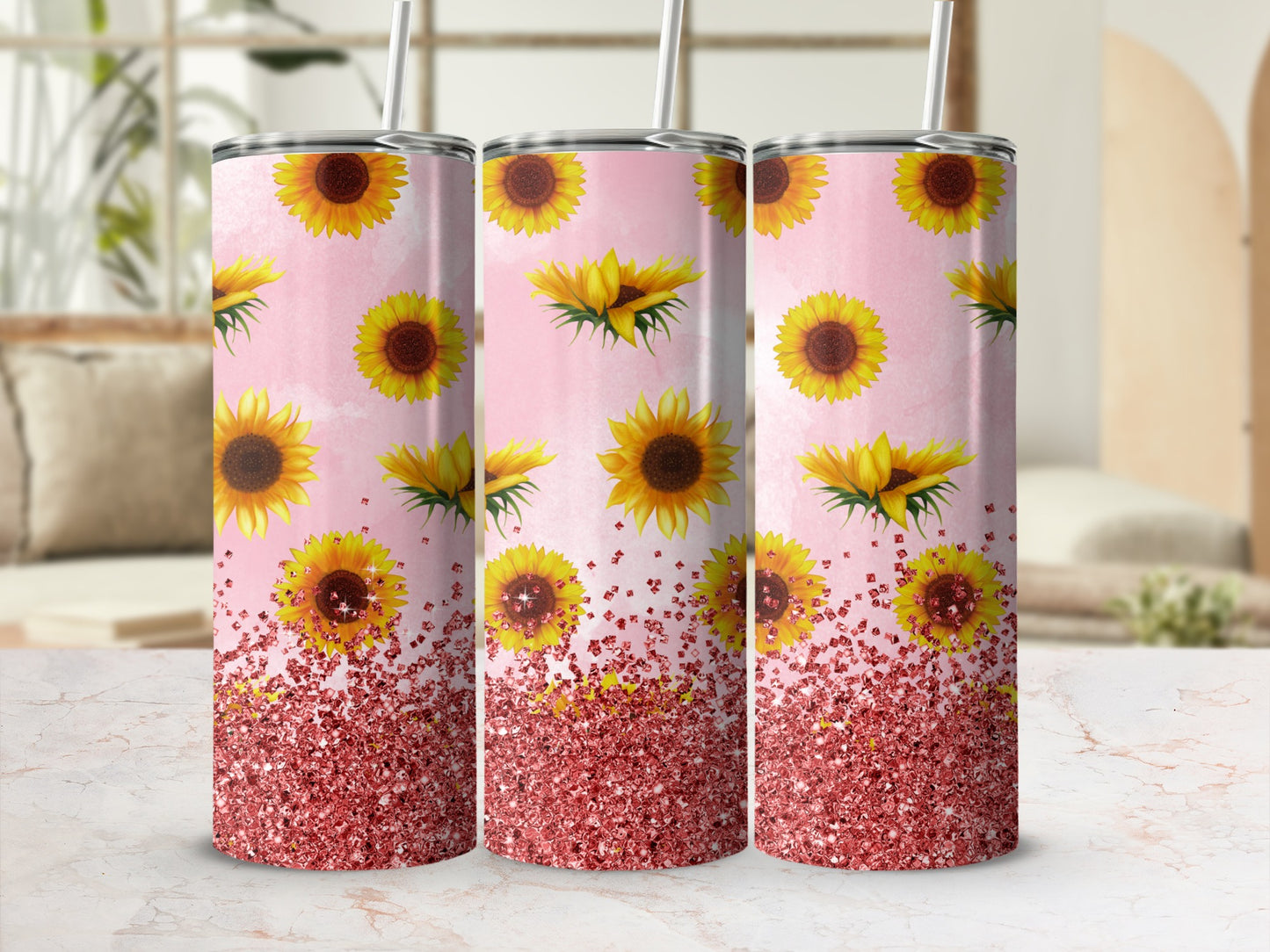 Three tumblers with sunflowers and rose gold glitter pattern on pink background.