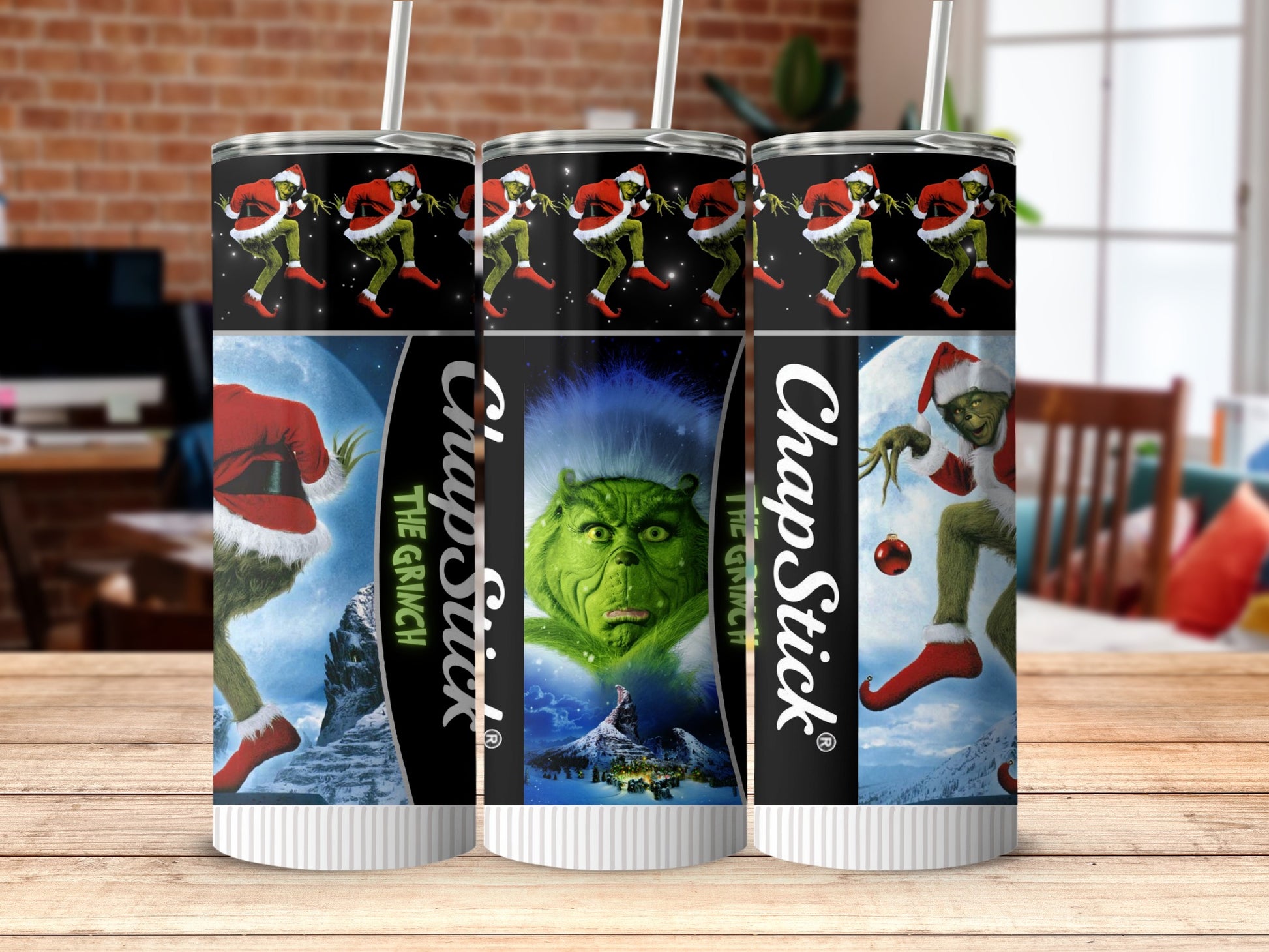 Three Grinch themed Chapstick tumblers with a patterned background of the Grinch.