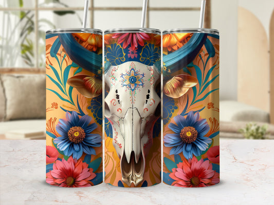 Cow skull with floral accents on a patterned tumbler with straws.