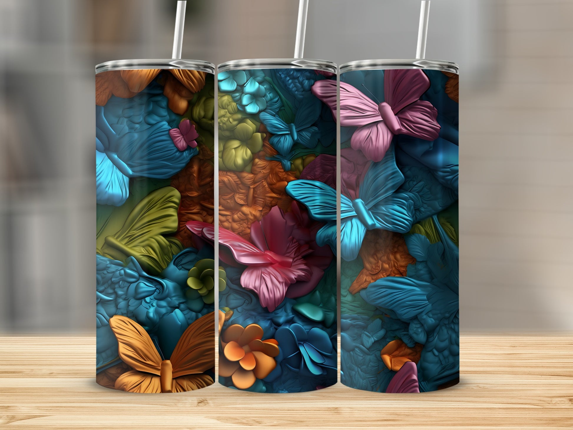 Three patterned tumblers with butterflies and floral designs.