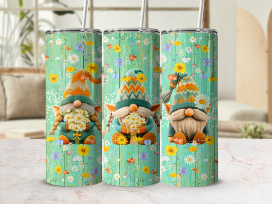 Three gnomes with flowers and floral patterned hats on a teal wood background.