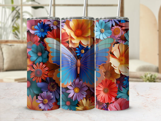 Three floral tumblers with a butterfly design on a marble surface.
