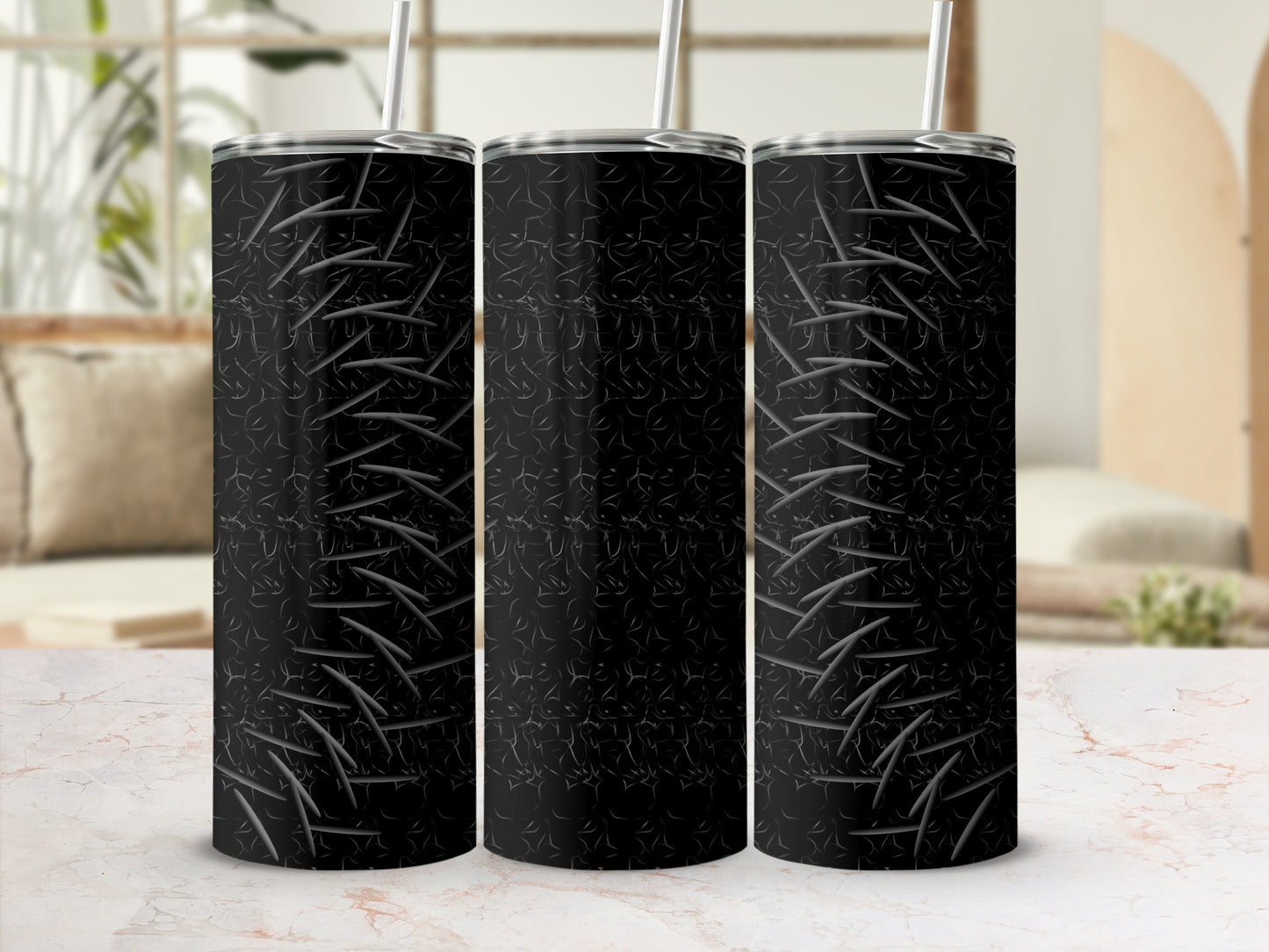 Three black tumblers with a scratched metal pattern and straws.