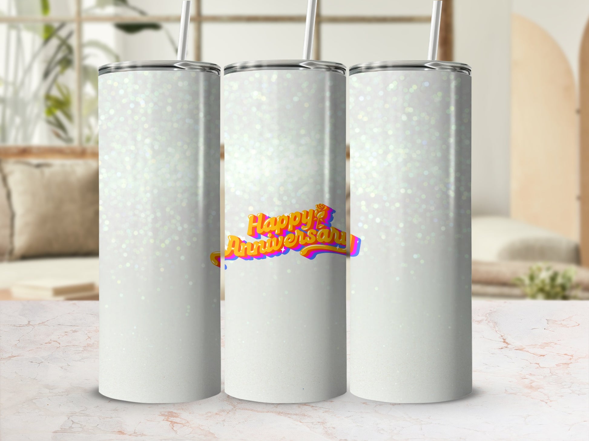 Three white tumblers with "Happy Anniversary" text on the middle one.