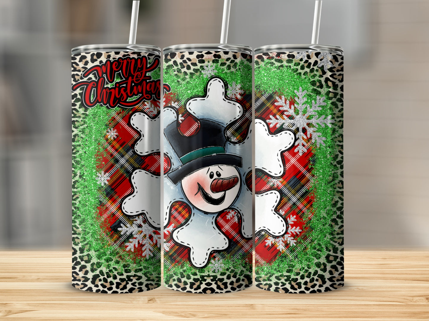 Three tumblers with snowman, plaid, snowflake, and leopard print designs.