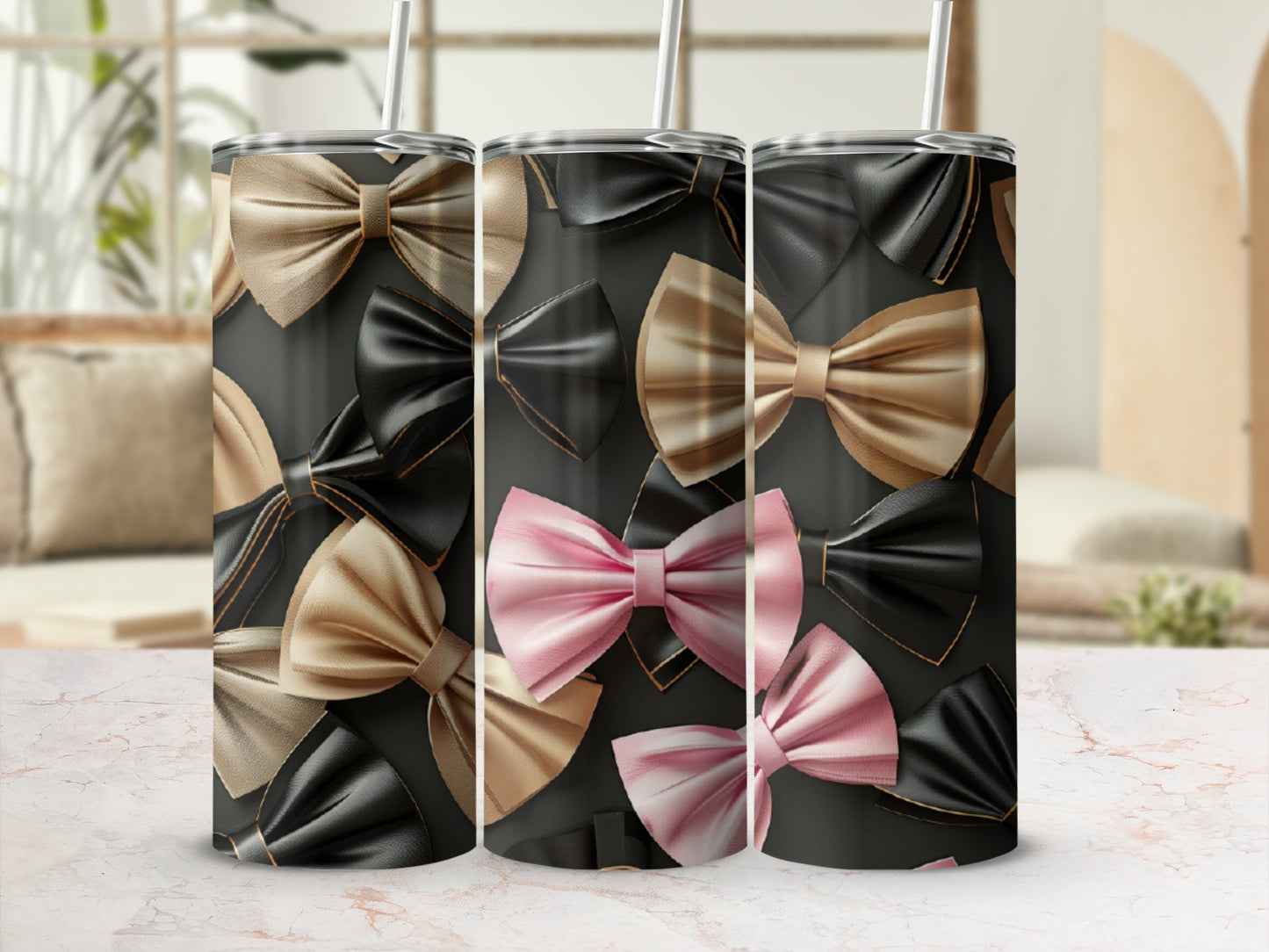 Three tumblers with a bow pattern in black, gold, and pink.