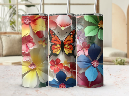 Three floral tumblers with butterfly design in front of blurred background.