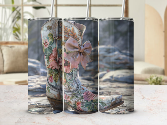 Cowboy boot with floral pattern and pink bow on a textured background.