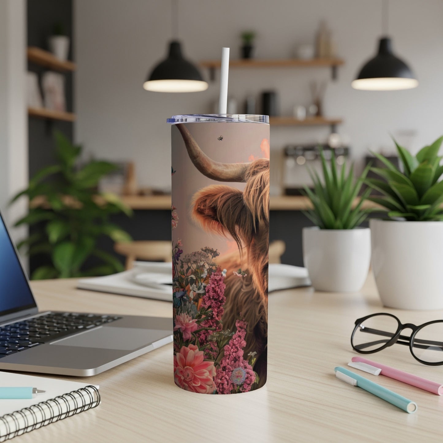 Highland cow with floral accents on a tumbler.