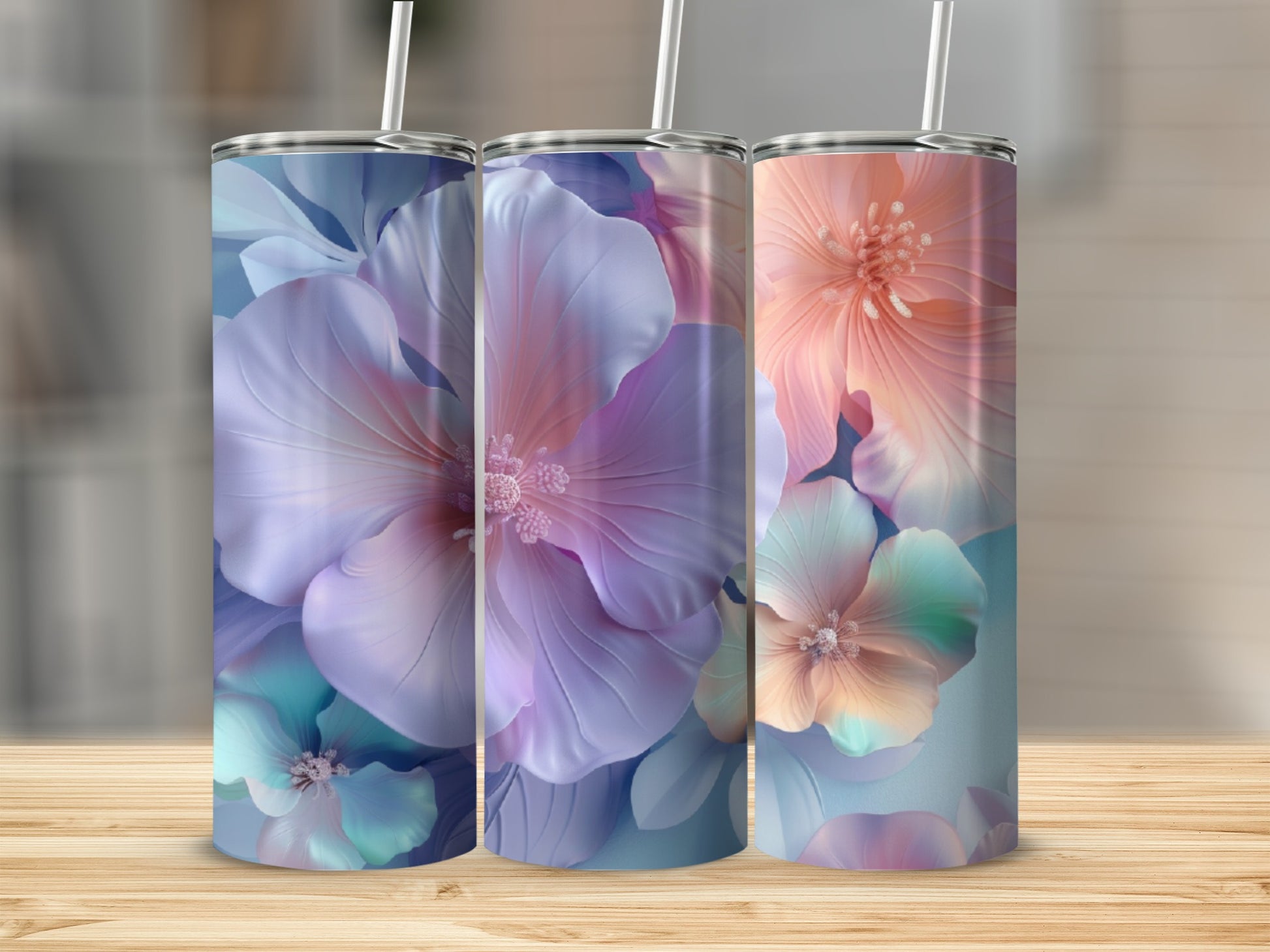 Three tumblers with floral designs in shades of purple, blue, and peach.