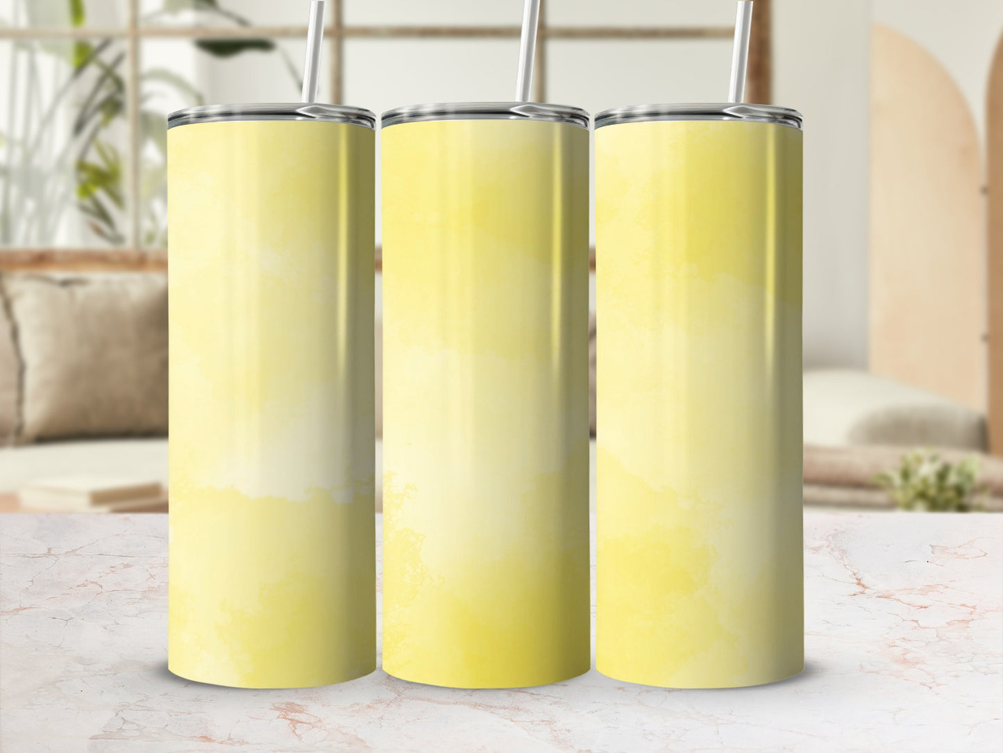 Three yellow ombre tumblers with straws arranged side-by-side.