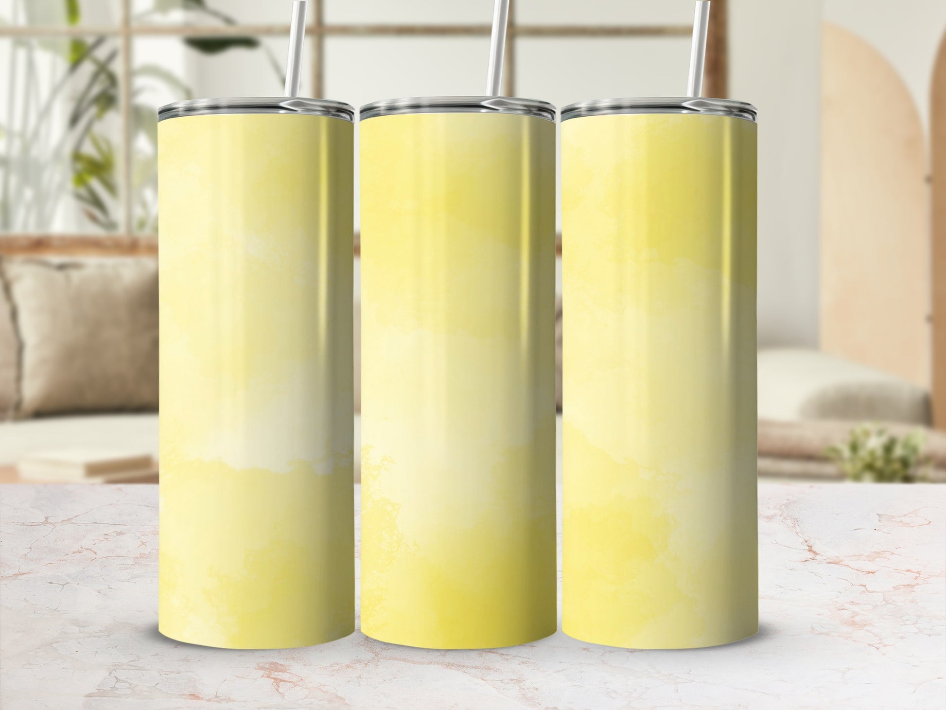 Three yellow ombre tumblers with straws arranged side-by-side.