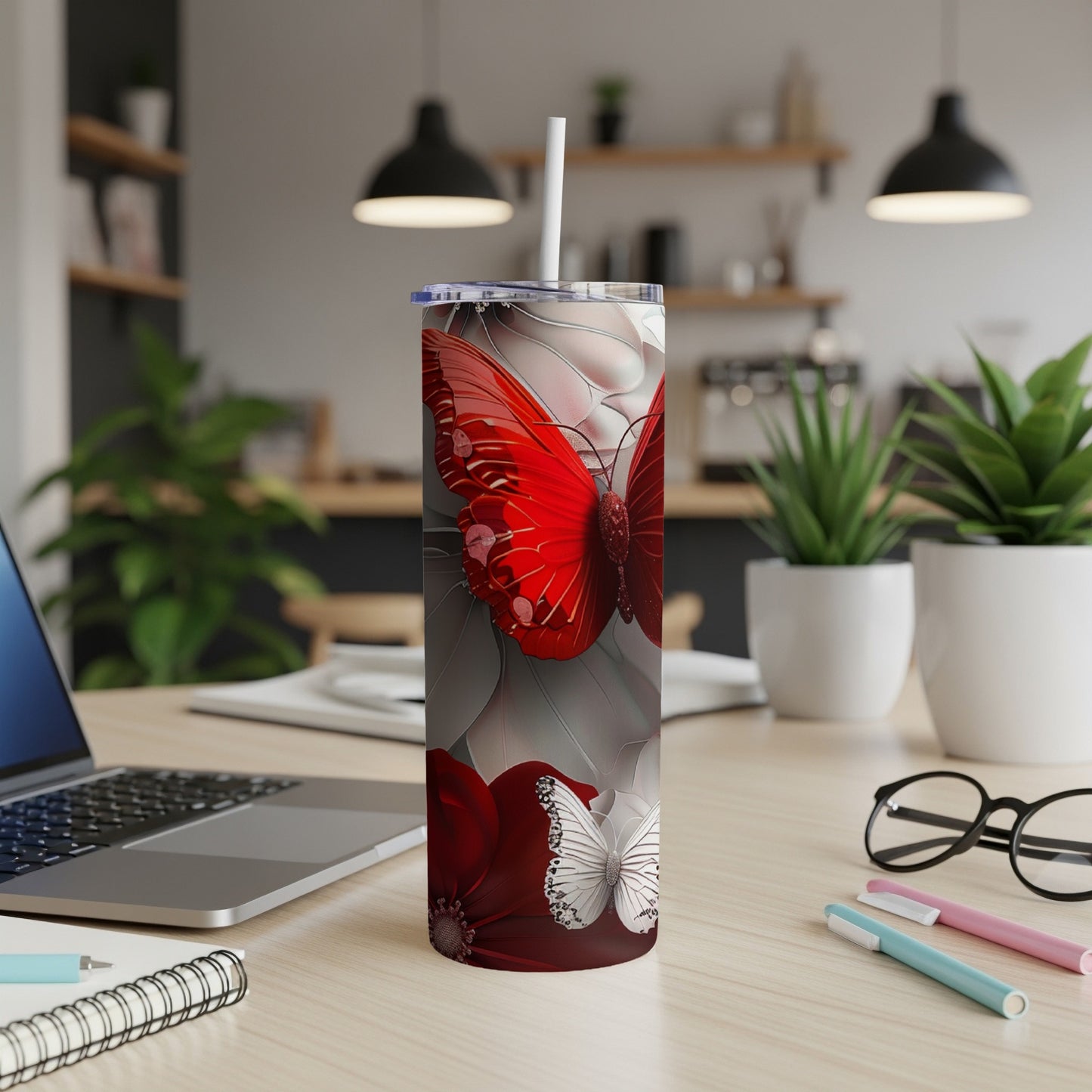 Tall tumbler with red and white butterfly design.
