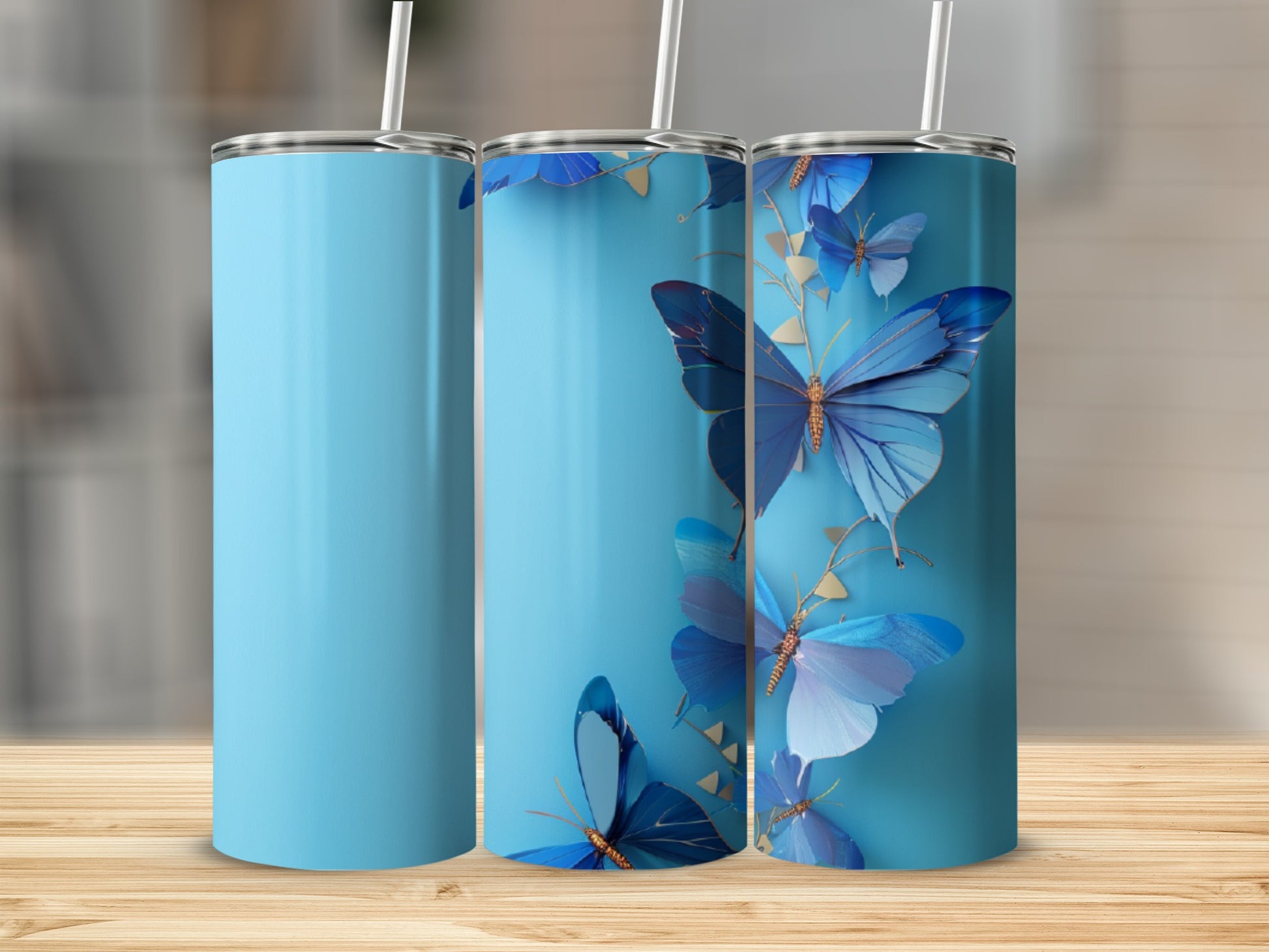 Three light blue tumblers with gold-accented blue butterflies and vines.
