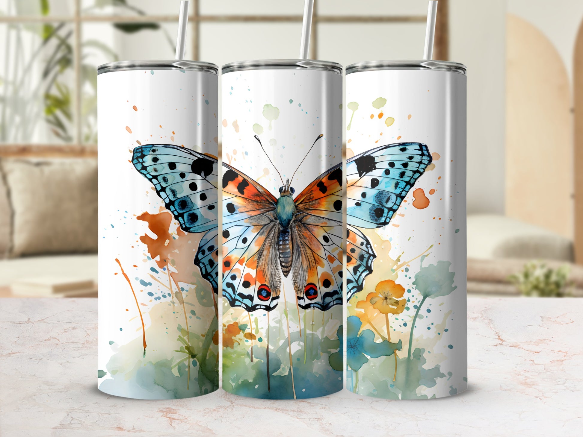 Three tumblers with watercolor butterfly and floral designs.