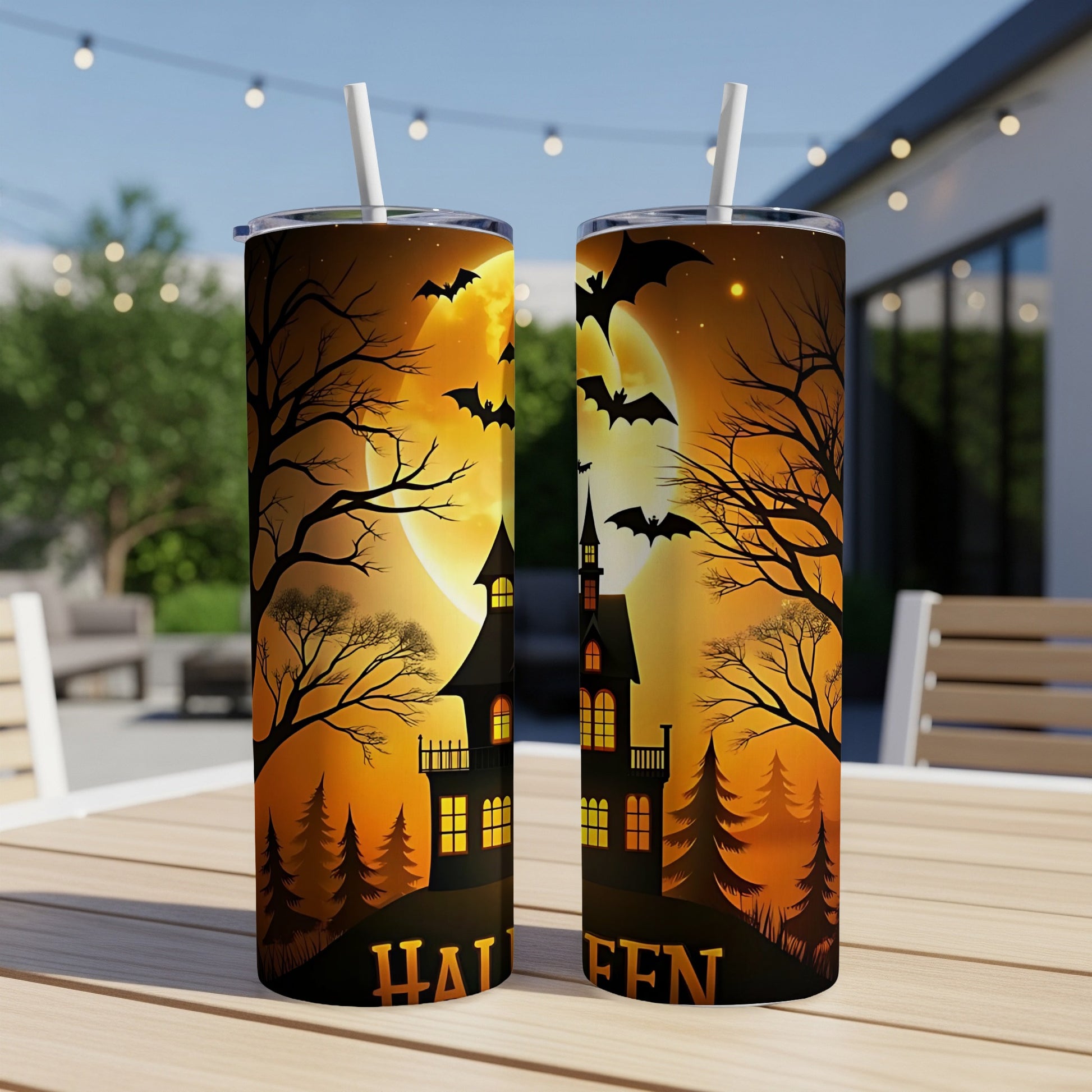 Two Halloween-themed tumblers with spooky houses, bats, and a full moon.