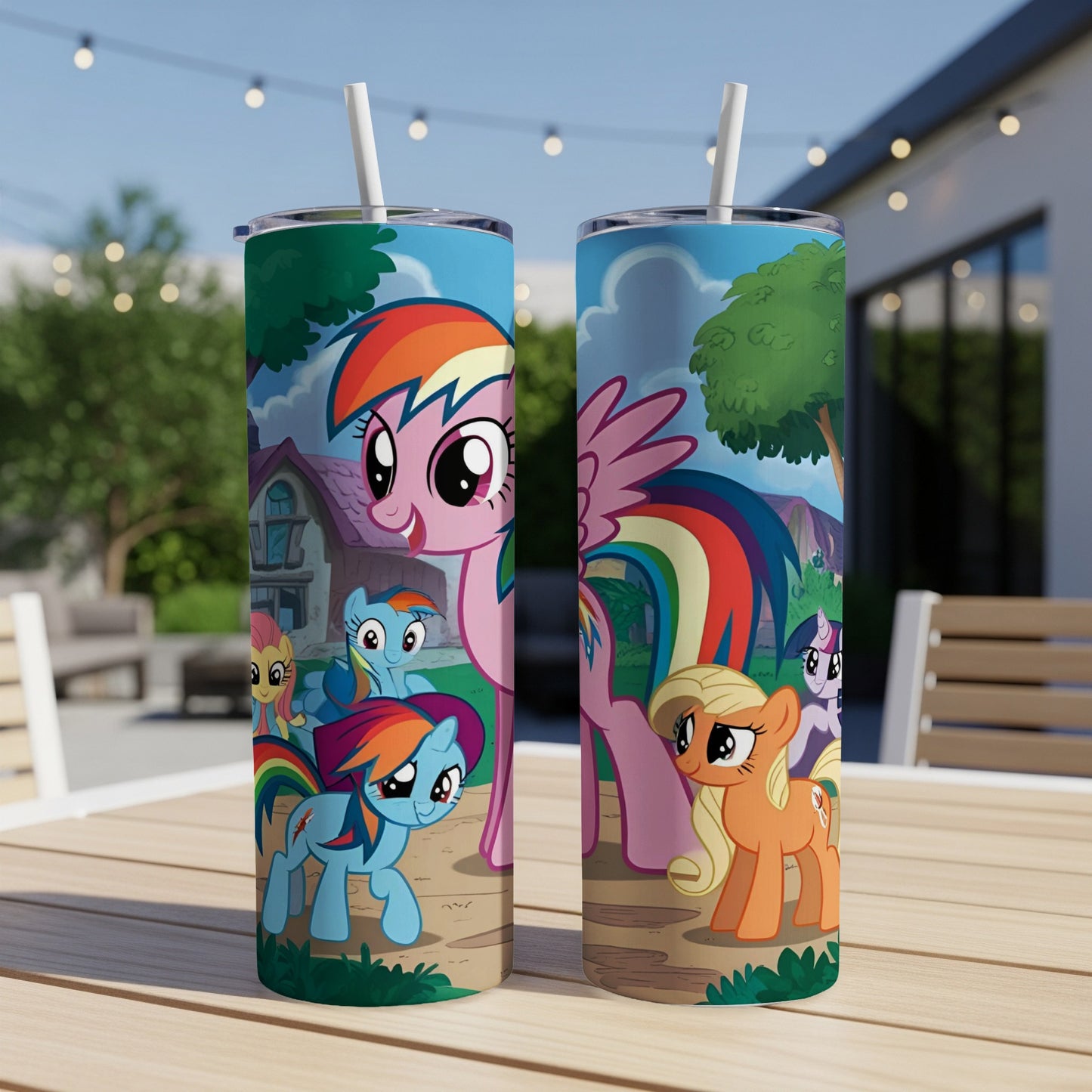 My Little Pony characters on a white tumbler with a straw, outdoors.