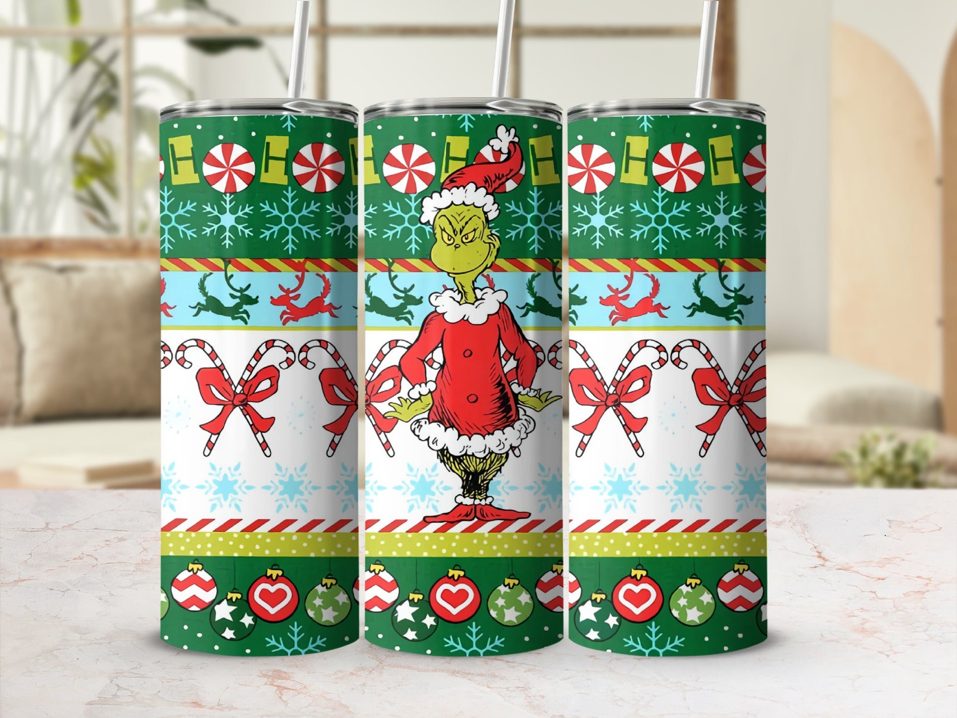 Green Grinch character on holiday patterned tumbler with candy canes and snowflakes.