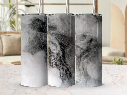 Three tumblers with smoky, abstract designs on a countertop.