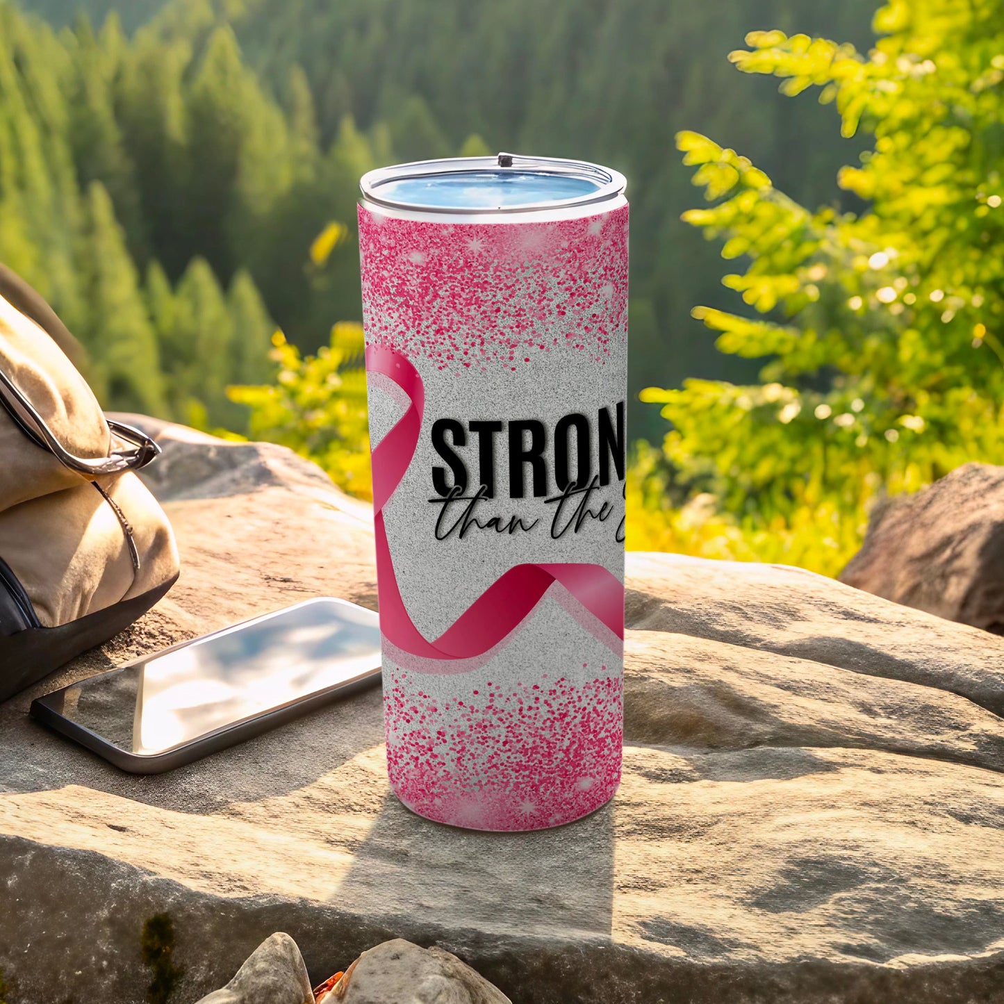 Pink tumbler with "Stronger Than the Storm" text and ribbon design.