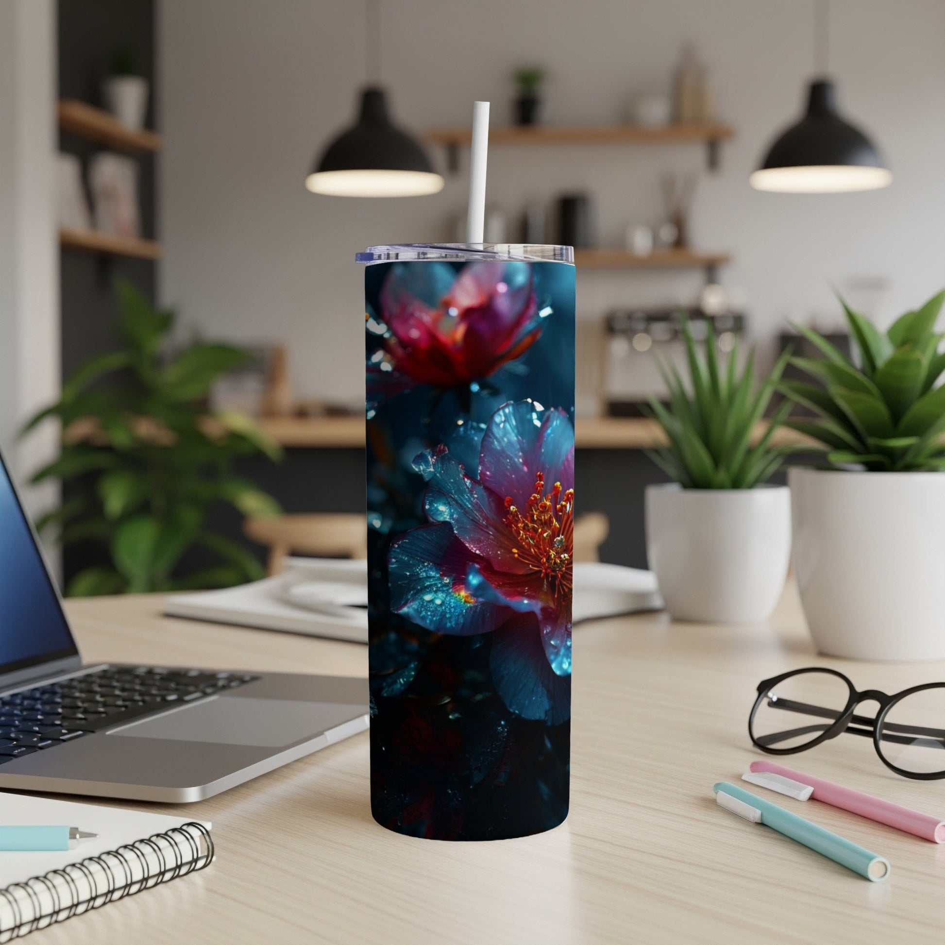 Pink and blue floral pattern on a stainless steel tumbler with a straw.
