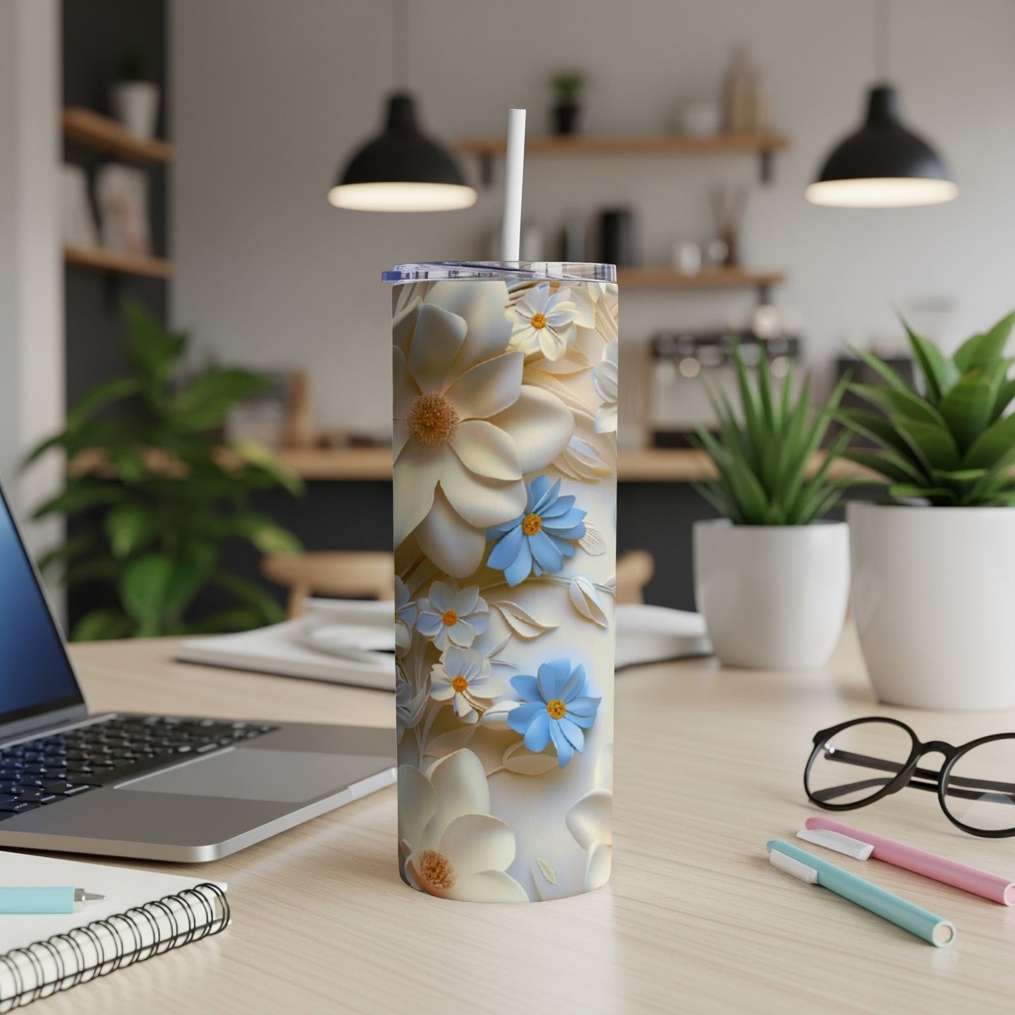 White and blue floral pattern on a white insulated tumbler with a straw.